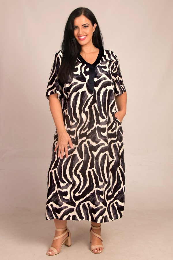Our model is wearing Mona Lisa abstract print dress in navy for Froxx Clothing